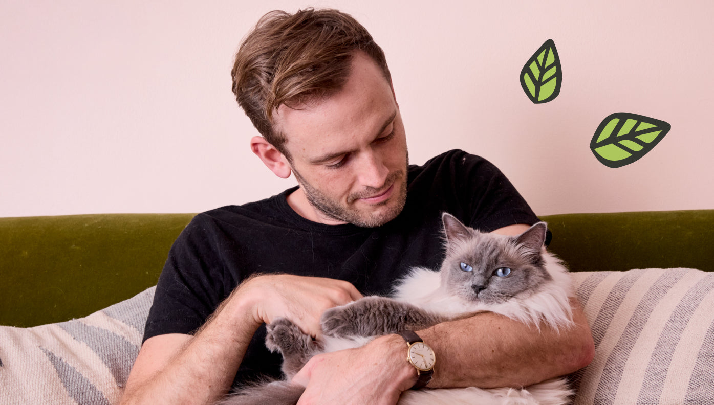 Rory the Vet holding a cat in his arms