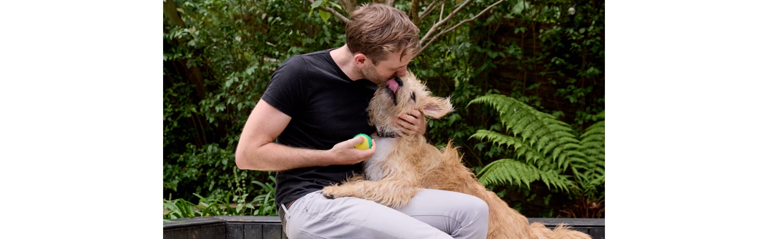 picture of Rory The Vet cuddling a dog