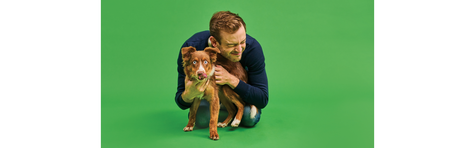 picture of a Rory The Vet cuddling a dog
