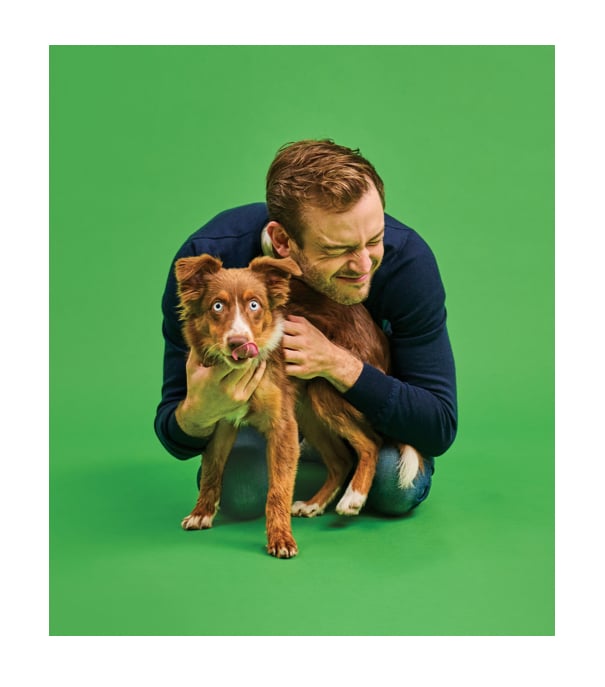 picture of a Rory The Vet cuddling a dog